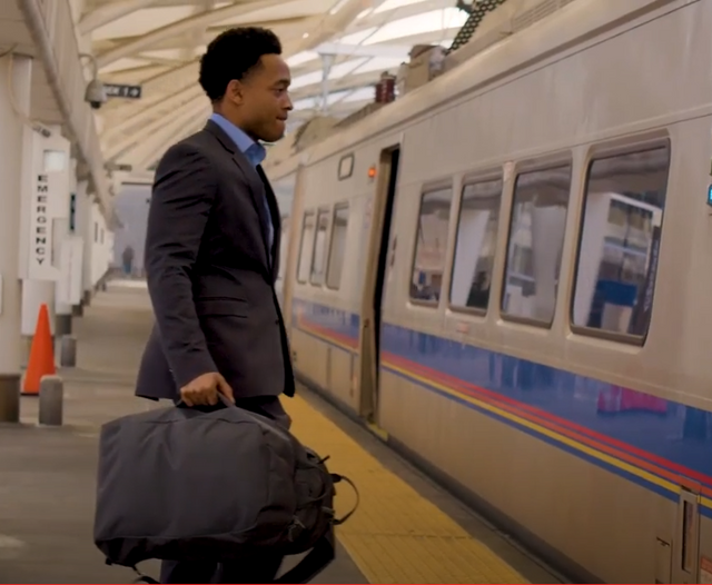 guy getting on train with perfect backpack